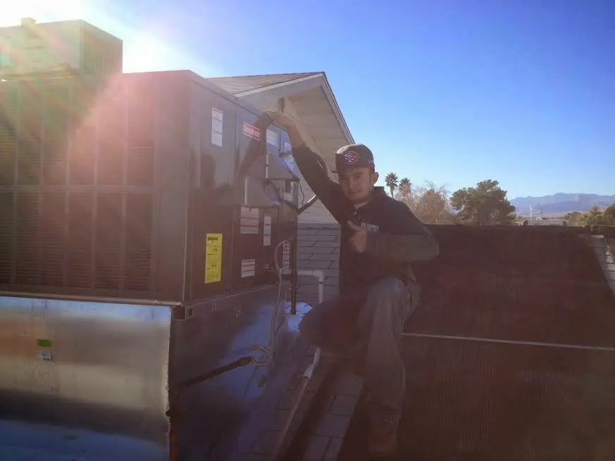 HVAC technician performing AC Tune-Up on a rooftop unit in South Bay